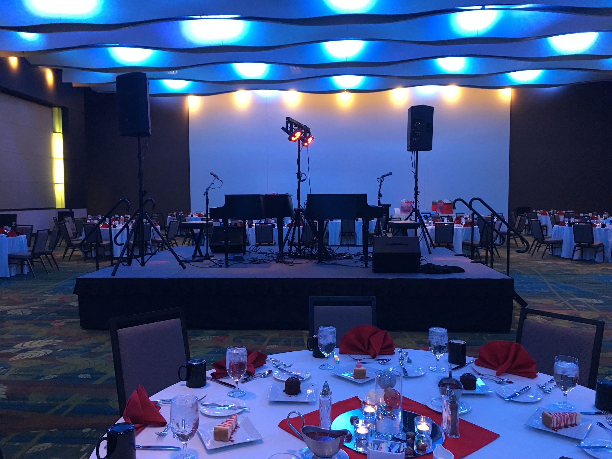 Professional dueling piano stage setup for a corporate event