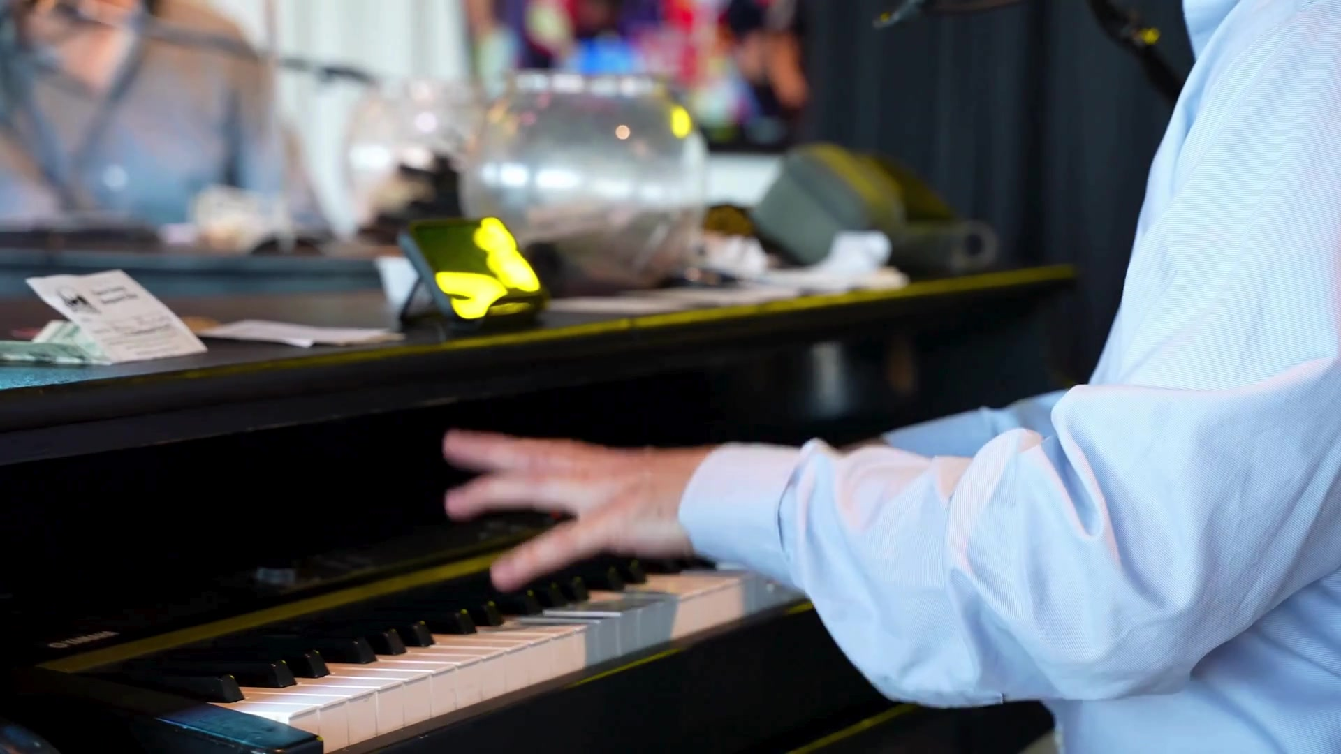 Close-up of a Midwest Dueling Pianos performer’s hands over the piano keys.